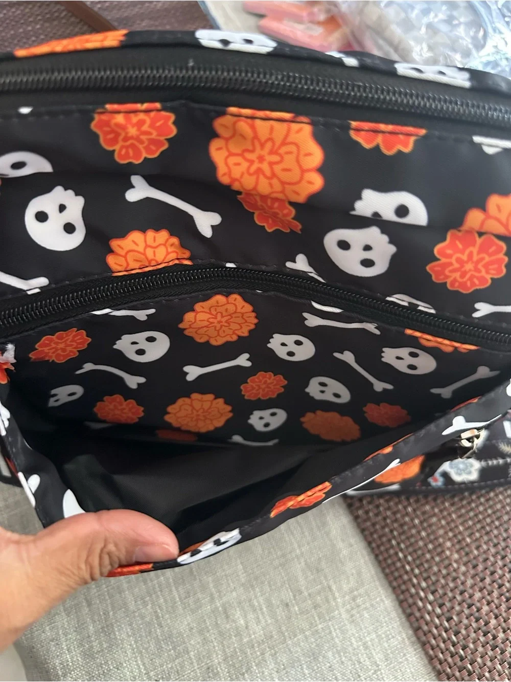 Halloween-themed crossbody bag featuring a skull and marigold print